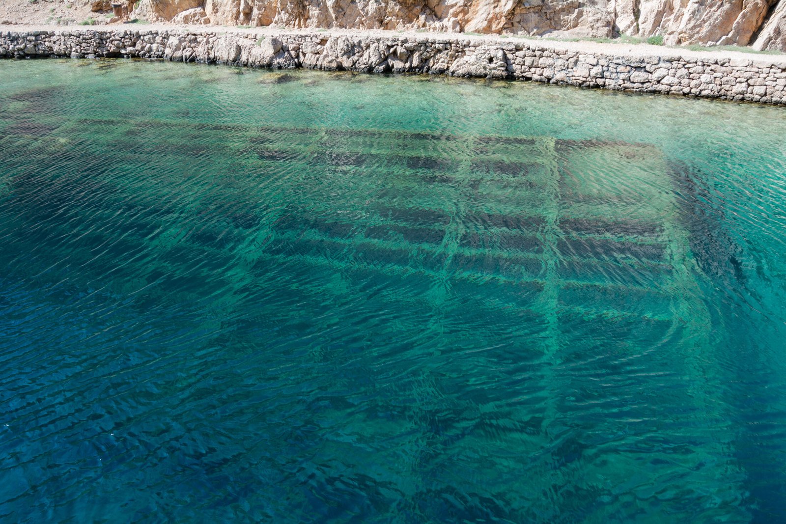 Real photograph of clear water and the historic wreck in Zavratnica Cove